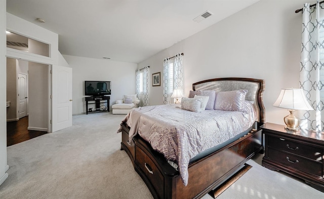 carpeted bedroom featuring visible vents
