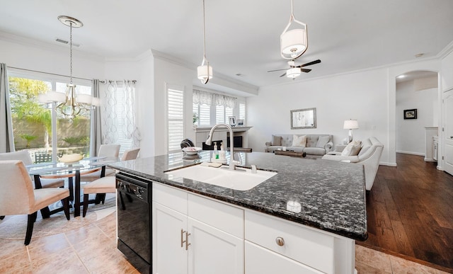 kitchen with a sink, visible vents, ornamental molding, and dishwasher