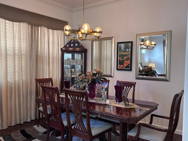 dining room featuring ornamental molding, wood finished floors, baseboards, and an inviting chandelier