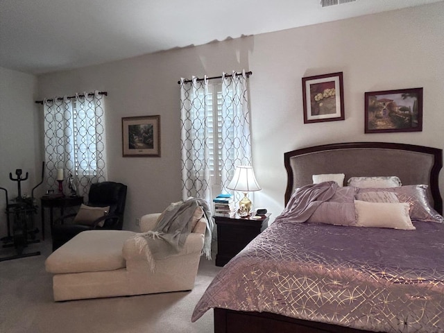 bedroom with visible vents and carpet flooring