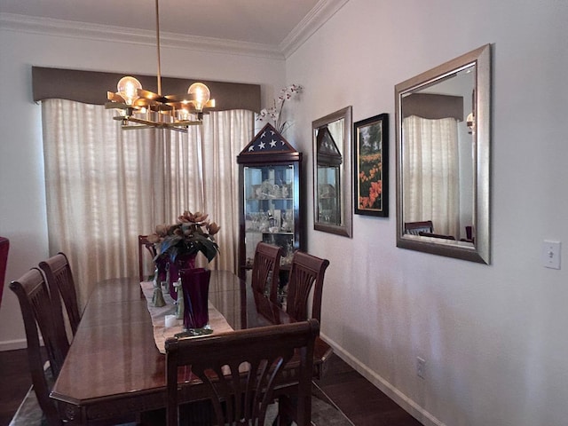 dining space featuring baseboards, wood finished floors, a chandelier, and crown molding