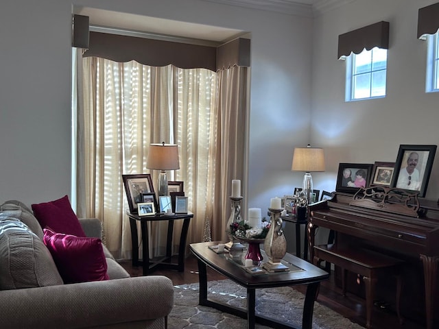 living room featuring wood finished floors and crown molding