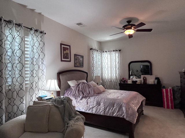 bedroom with carpet flooring, visible vents, and a ceiling fan