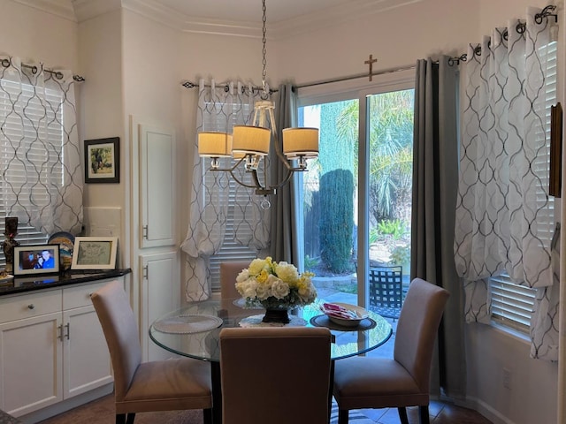 dining room with ornamental molding and a notable chandelier