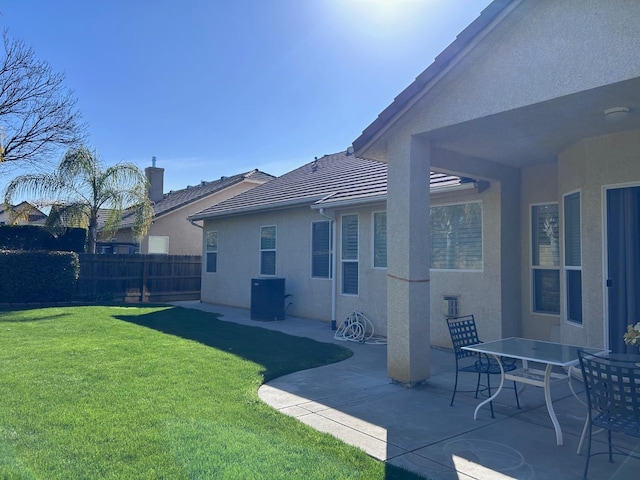 view of yard featuring central AC unit, a patio area, and fence