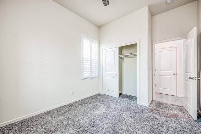 unfurnished bedroom featuring carpet floors, a closet, and baseboards