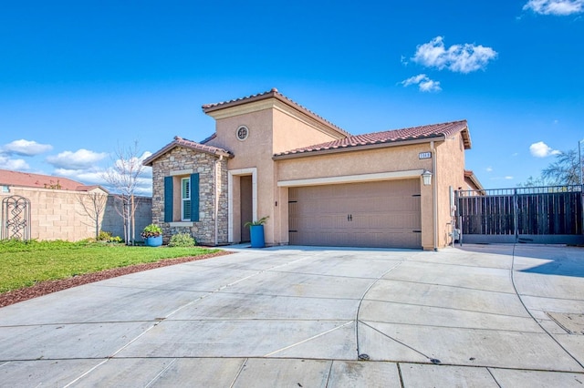 mediterranean / spanish-style home with stone siding, driveway, and stucco siding