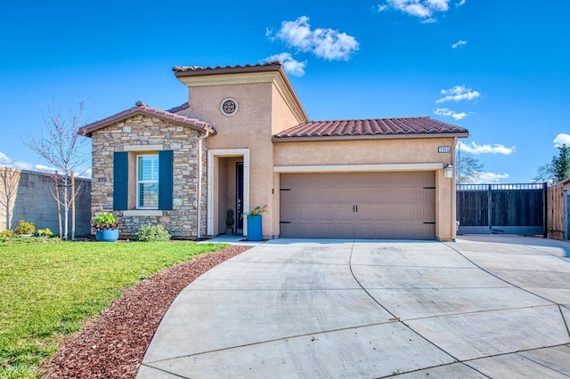 mediterranean / spanish home with driveway, a garage, stucco siding, a tile roof, and a front yard