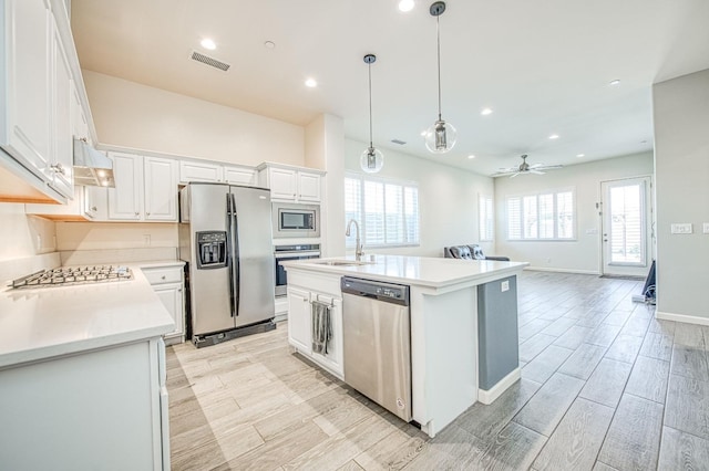 kitchen with visible vents, white cabinets, appliances with stainless steel finishes, light countertops, and a sink