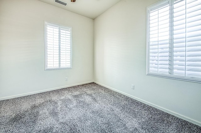 unfurnished room with carpet, baseboards, and visible vents