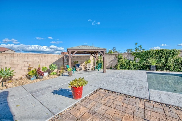 view of patio / terrace featuring a fenced backyard and a gazebo