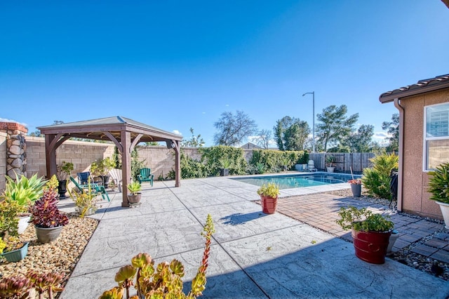 view of swimming pool with a gazebo, a fenced backyard, a fenced in pool, and a patio