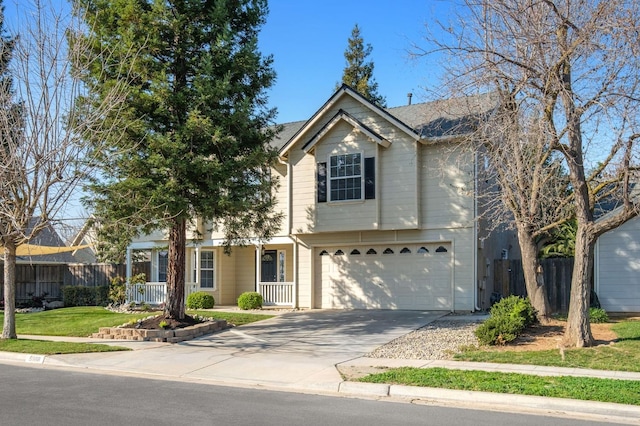 traditional-style house featuring driveway, a porch, an attached garage, and fence