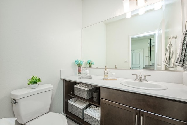 bathroom with toilet and vanity