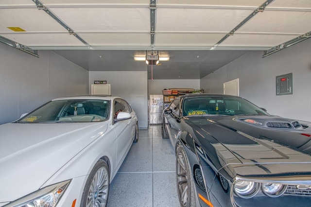 garage with electric panel, washer / clothes dryer, and a garage door opener