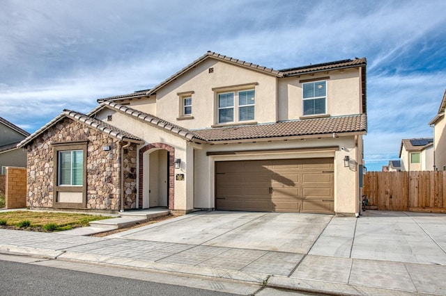 mediterranean / spanish-style house with stucco siding, fence, a garage, driveway, and a tiled roof