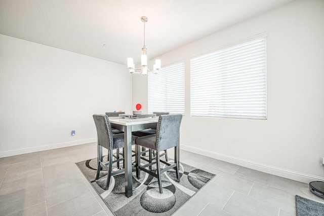 dining room featuring baseboards, a notable chandelier, and light tile patterned flooring