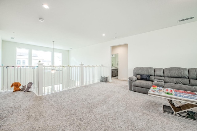 living room with carpet floors, visible vents, and recessed lighting