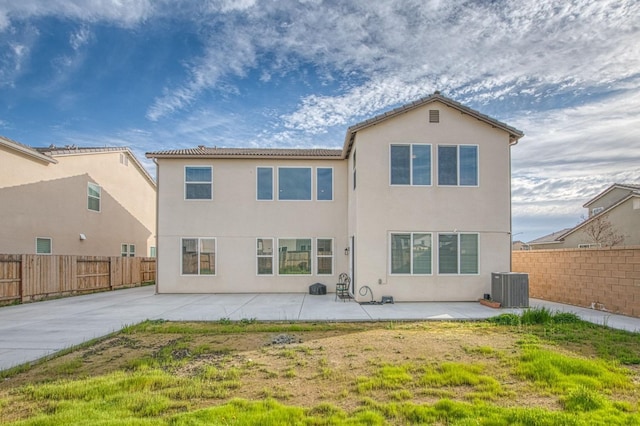 back of property featuring a patio, cooling unit, a fenced backyard, and stucco siding