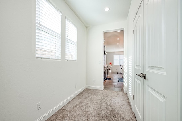 interior space featuring light carpet, baseboards, and recessed lighting