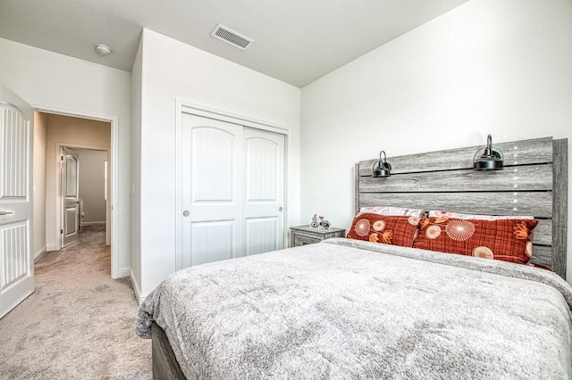 carpeted bedroom with a closet, visible vents, and baseboards