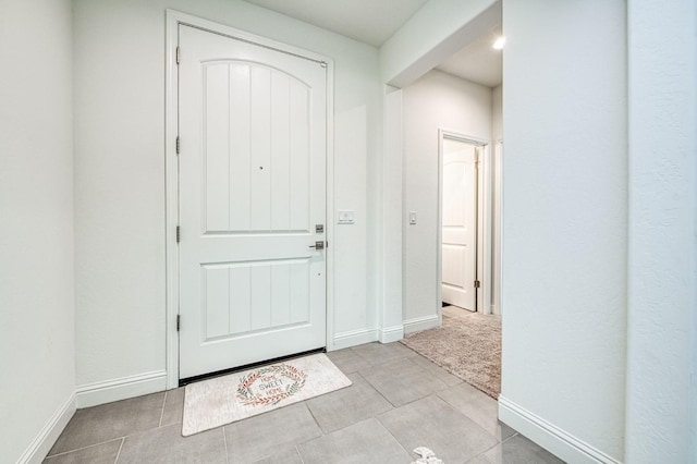 tiled foyer entrance featuring baseboards