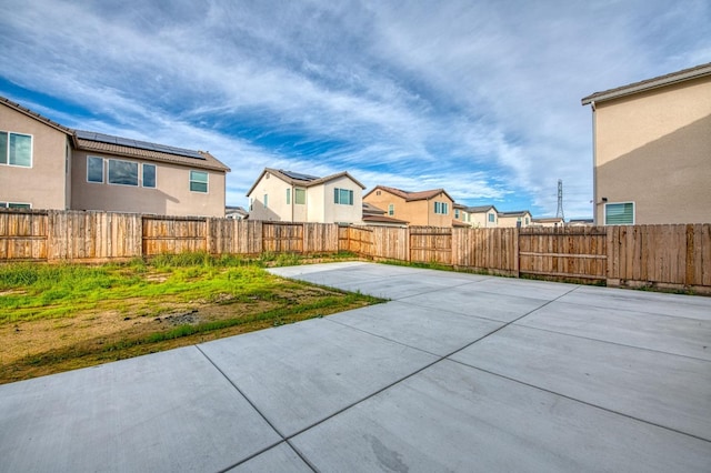 view of patio featuring a fenced backyard and a residential view