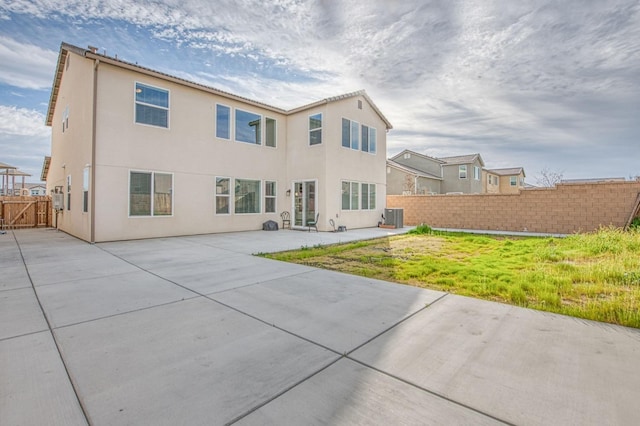 back of house featuring stucco siding, a patio area, cooling unit, and fence