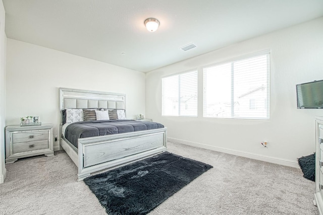 carpeted bedroom with visible vents and baseboards