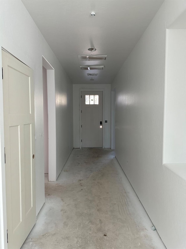 hallway with concrete floors