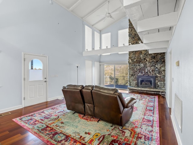 living area with visible vents, baseboards, a ceiling fan, wood finished floors, and high vaulted ceiling