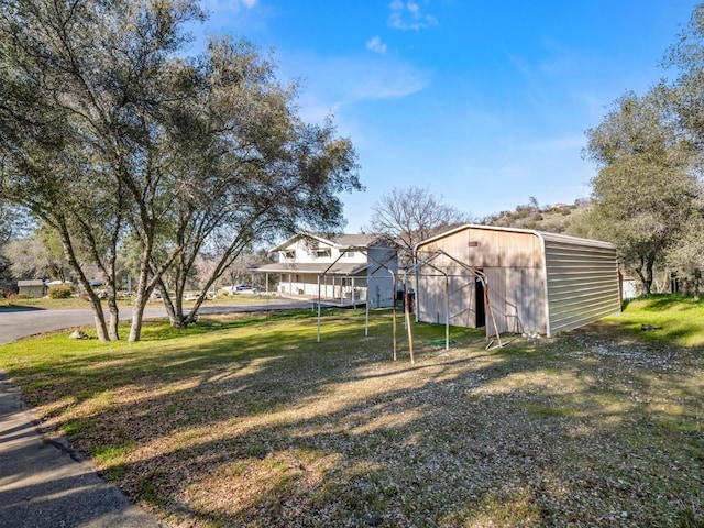 view of yard featuring an outbuilding and an outdoor structure