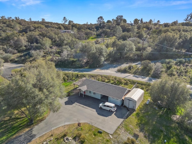 birds eye view of property with a view of trees