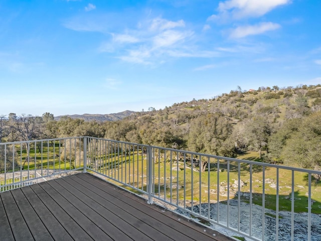 deck with a mountain view and a wooded view