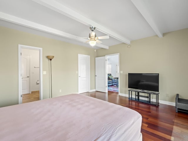 bedroom featuring baseboards, beam ceiling, and wood finished floors