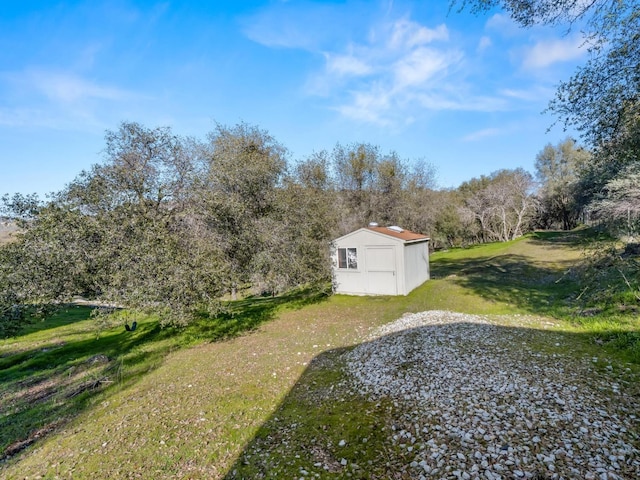 view of yard with an outbuilding and a shed