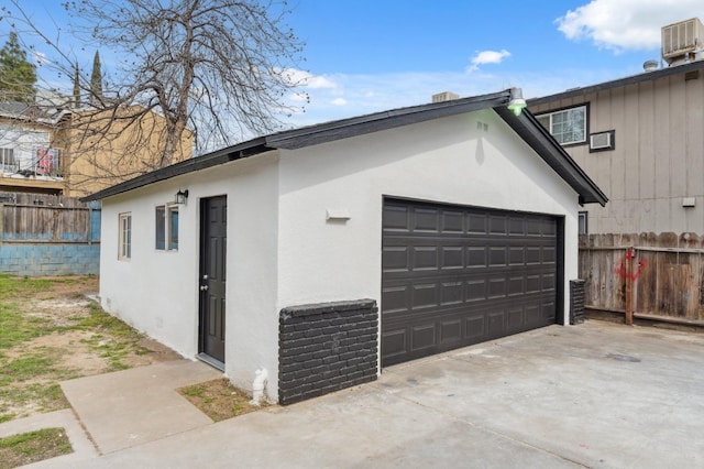 garage featuring cooling unit and fence