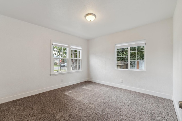 spare room with carpet floors and baseboards