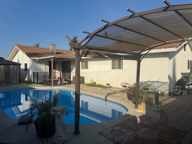 view of swimming pool featuring a patio and a fenced in pool