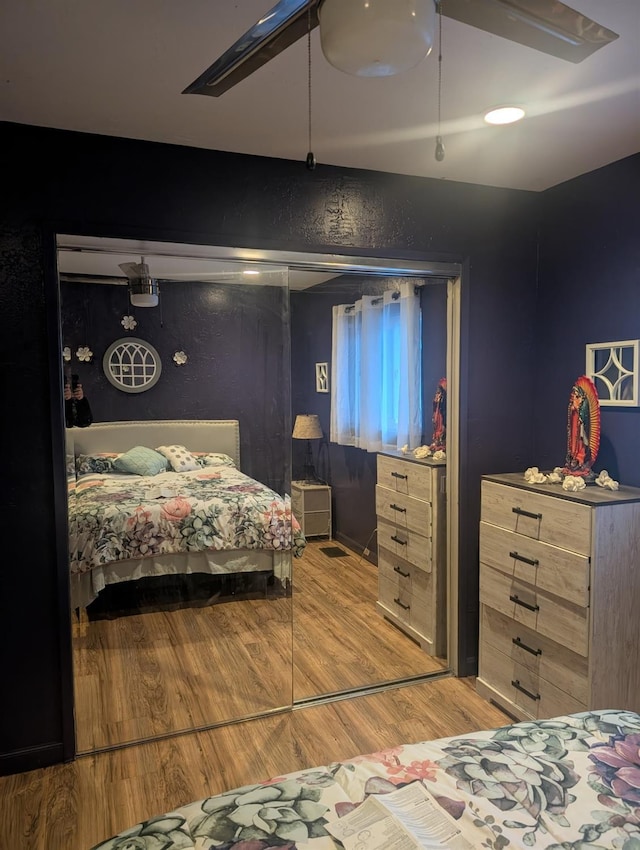 bedroom with ceiling fan and light wood-style floors