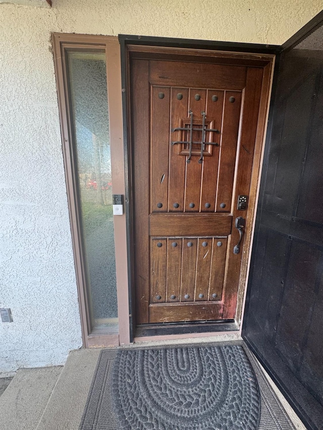 doorway to property with stucco siding