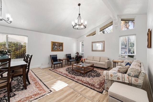 living room featuring a chandelier, plenty of natural light, wood finished floors, and baseboards