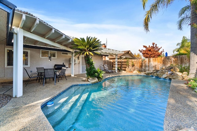 view of swimming pool featuring a patio area, fence, a fenced in pool, and a pergola