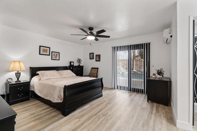 bedroom featuring light wood-type flooring, access to exterior, baseboards, and a wall mounted air conditioner