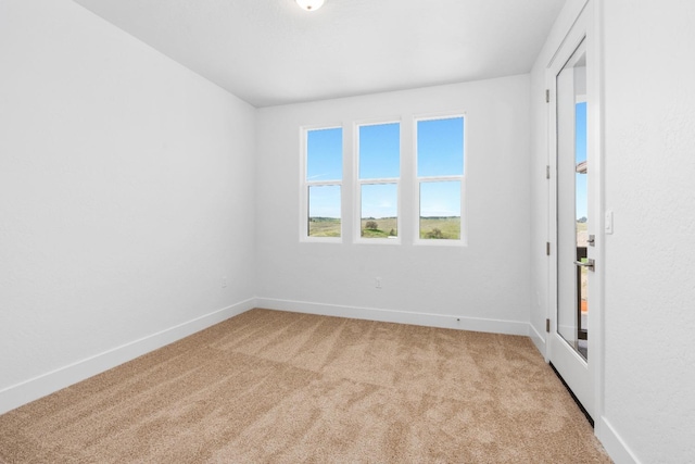 empty room with light carpet and baseboards