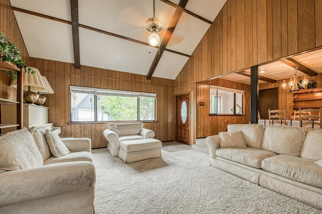 carpeted living area featuring a ceiling fan, beamed ceiling, and wooden walls