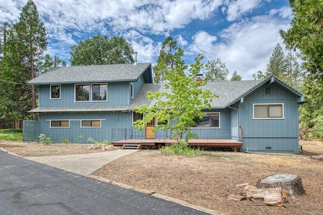 view of front of property featuring roof with shingles, crawl space, and a chimney