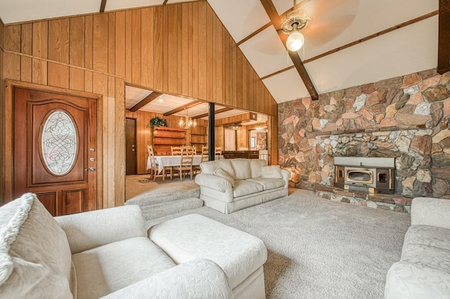 living room with high vaulted ceiling, wood walls, carpet flooring, a ceiling fan, and beamed ceiling