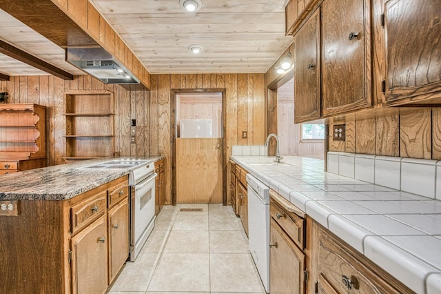 kitchen featuring white appliances, light tile patterned floors, wooden ceiling, under cabinet range hood, and a sink