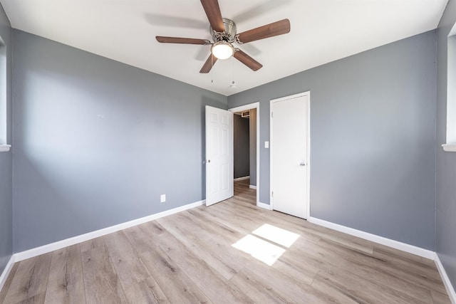 unfurnished bedroom featuring a ceiling fan, wood finished floors, and baseboards